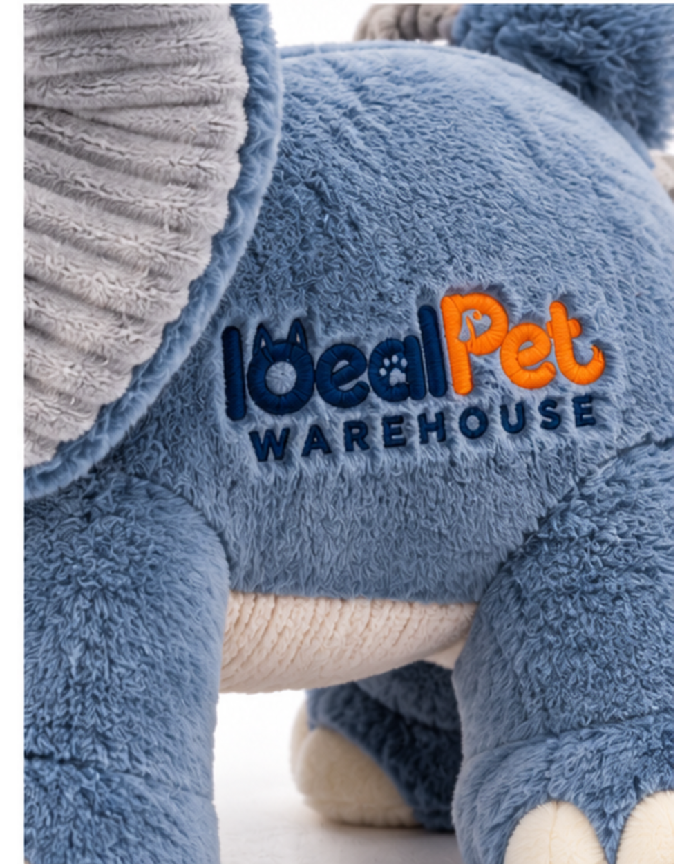 Close-up of the embroidered logo on the side of the blue plush elephant